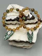 Load image into Gallery viewer, Green-White Qinghai Green Jasper Stone Beaded Hoop Earrings provide a nature-inspired look that is perfect for any boho-chic style. These earrings feature natural green jasper stone triangle pendant with champagne mix melon Czech faceted round glass beads.  Glass beads have a tint of light champagne, amber, dark green and gold shimmer for subtle accent. Show off your bohemian look with these eye-catching hoops. Antique Copper Plated Surgical Steel Hammered Long Ear-wire French Hook Earrings. 
