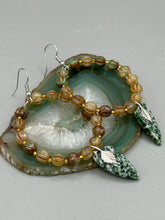 Load image into Gallery viewer, Green-White Qinghai Green Jasper Stone Beaded Hoop Earrings provide a nature-inspired look that is perfect for any boho-chic style. These earrings feature natural green jasper stone triangle pendant with champagne mix melon Czech faceted round glass beads.  Glass beads have a tint of light champagne, amber, dark green and gold shimmer for subtle accent. Show off your bohemian look with these eye-catching hoops. Antique Copper Plated Surgical Steel Hammered Long Ear-wire French Hook Earrings. 
