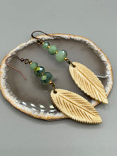 Load image into Gallery viewer, Single-stranded earring features bone carved leaf charm earrings with light mint faceted round glass beads.  Glass beads have a tint of dark green and gold shimmer. Antique Copper Plated Surgical Steel Hammered Long Ear-wire French Hook Earrings.  Measurements: 3” in length  
