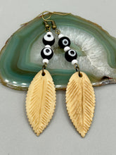 Load image into Gallery viewer, Single-stranded earring features bone carved leaf charm earrings with black and white eye-dot glass beads. Antique Copper Plated Surgical Steel Hammered Long Ear-wire French Hook Earrings.  Measurements: 3” in length  
