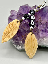 Load image into Gallery viewer, Single-stranded earring features bone carved leaf charm earrings with black and white eye-dot glass beads. Antique Copper Plated Surgical Steel Hammered Long Ear-wire French Hook Earrings.  Measurements: 3” in length  
