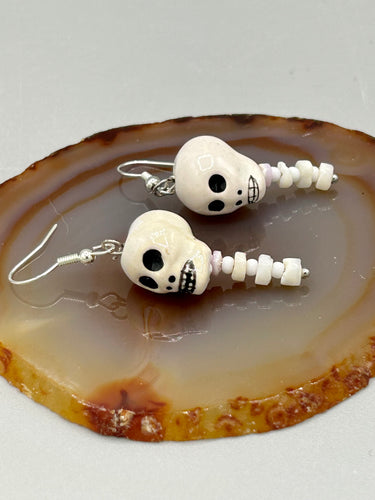 Peruvian off white ceramic skull beads come with spine earrings. These stylish skull earrings are perfect for adding a unique flair to any outfit. Whether you're looking for a Dia De Los Muertos accessory or simply looking to draw inspiration, these goth pieces perfectly capture the vampire goth, witchy, dark, Chingona Cabrona, Latina Chicana styles.   Measurements: 1 1/4” in length