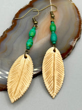 Load image into Gallery viewer, Single-stranded earring features bone carved leaf charm earrings with bright green magnesite stone beads. Antique antique brass plated steel ear-wire French Hook Earrings.  Measurements: 3” in length   
