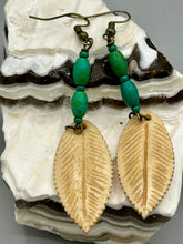 Load image into Gallery viewer, Single-stranded earring features bone carved leaf charm earrings with bright green magnesite stone beads. Antique antique brass plated steel ear-wire French Hook Earrings.  Measurements: 3” in length   
