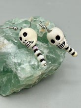 Load image into Gallery viewer, Spooky skull peruvian ceramic beads come with spine earrings. These stylish skull earrings are perfect for adding a unique flair to any outfit. Whether you&#39;re looking for a Dia De Los Muertos accessory or simply looking to draw inspiration, these goth pieces perfectly capture the vampire goth, witchy, dark, Chingona Cabrona, Latina Chicana styles.   Measurements: 1 1/2” in length 
