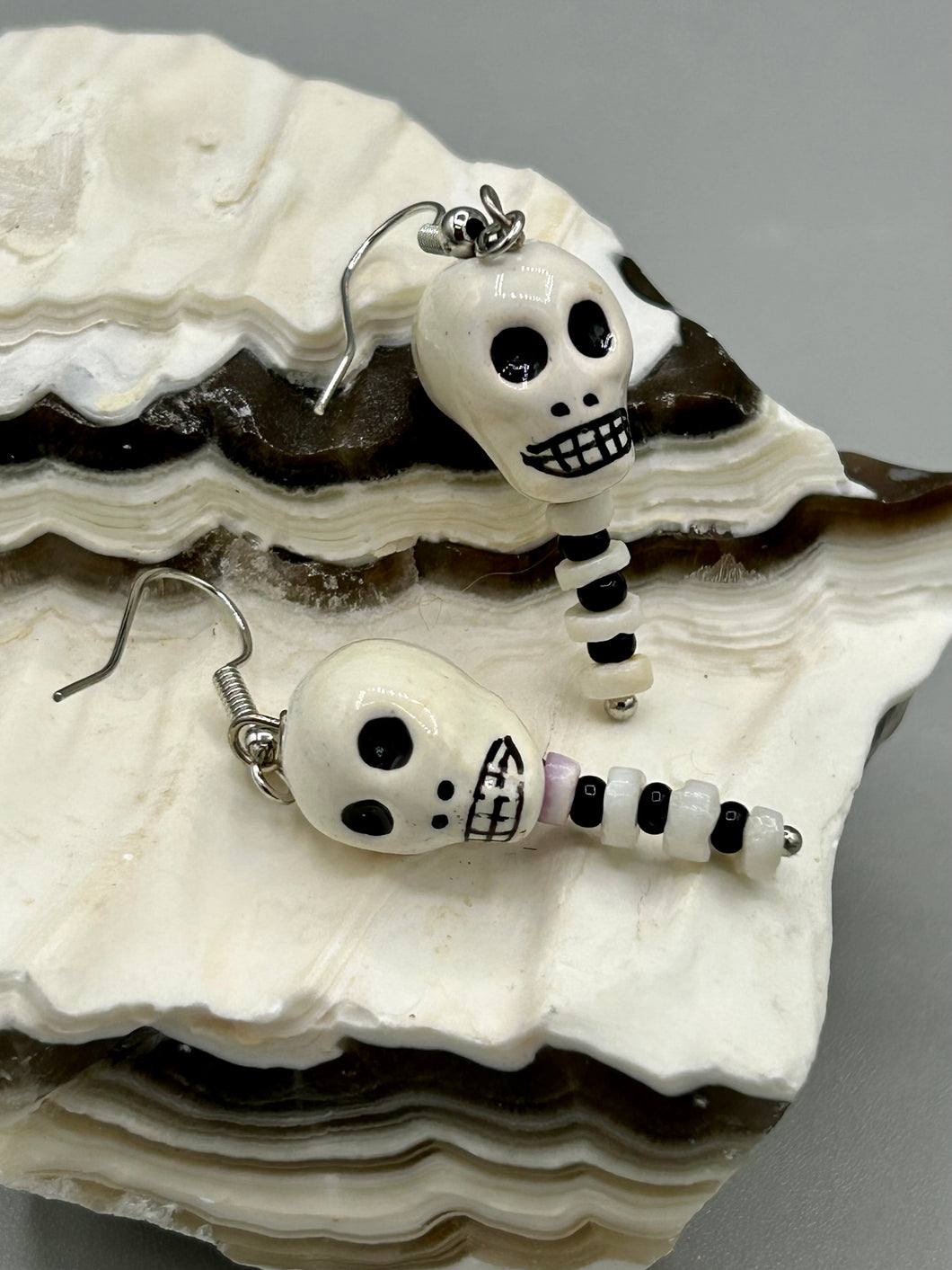 Spooky skull peruvian ceramic beads come with spine earrings. These stylish skull earrings are perfect for adding a unique flair to any outfit. Whether you're looking for a Dia De Los Muertos accessory or simply looking to draw inspiration, these goth pieces perfectly capture the vampire goth, witchy, dark, Chingona Cabrona, Latina Chicana styles.   Measurements: 1 1/2” in length 