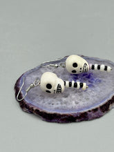 Load image into Gallery viewer, Spooky skull peruvian ceramic beads come with spine earrings. These stylish skull earrings are perfect for adding a unique flair to any outfit. Whether you&#39;re looking for a Dia De Los Muertos accessory or simply looking to draw inspiration, these goth pieces perfectly capture the vampire goth, witchy, dark, Chingona Cabrona, Latina Chicana styles.   Measurements: 1 1/2” in length 
