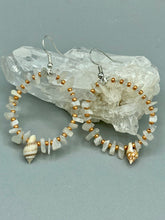 Load image into Gallery viewer, Delicate white moon stone chip and glass beaded hoop earrings featuring chic gold accents and tiny conch shells. Perfect for nature lovers, these boho-inspired summer earrings will add a subtle sophistication to any outfit.  Measurements: 2&quot; length
