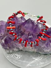 Load image into Gallery viewer, This distinctive Southwestern Style bracelet boasts a captivating combination of large red coral and blue-green turquoise glass beads for a visual impact. Crafted with metal wire and fastened with a lobster claw clasp, this bracelet is sure to command attention.  Measurements:  Bracelet: 8&quot; in length 
