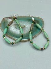 Load image into Gallery viewer, These stylish fish hook style earrings feature intricate beadwork crafted with forest green magnesite and ruby zoisite stones.  Measurements: 2 3/4&quot; length
