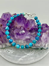 Load image into Gallery viewer, Nature inspired single-strand sea blue stripped agate round stone beaded with silver glass beaded bracelet. Crafted with metal wire and fastened with a lobster claw clasp.  Measurements:  Bracelet: 8&quot; in length   
