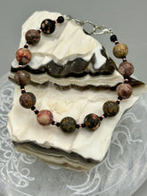 Load image into Gallery viewer, Nature inspired single-strand leopard jasper round stone beads with gold and black glass beaded bracelet. Leopard jasper stone has an array on neutral earth tones including soft pink, salmon, and gray tones. Crafted with metal wire and fastened with a lobster claw clasp.  Measurements:   Bracelet: 7 1/2&quot; in length   
