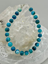 Load image into Gallery viewer, Nature inspired single-strand sea blue stripped agate round stone beaded with silver glass beaded bracelet. Crafted with metal wire and fastened with a lobster claw clasp.  Measurements:  Bracelet: 8&quot; in length   
