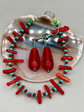 Load image into Gallery viewer, This eye-catching piece set of earrings consists of large fire engine red and tiny teal glass beads for a vibrant and bold look.  Measurements: 1 1/2” in length 
