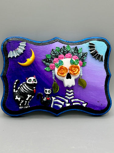 Frida Kahlo Inspired Wall Art | Dia De Los Muertos Home Decor.  La Catrina y Gatita wall art is the purrfect hanging Day of the Dead art piece to add to your ofrenda. A tribute to an unbreakable bond and eternal love between cats and their guardians. Featuring a vibrant and intricate detail catrina and her floral crown and her kitty cat companion, this Day of the Dead-inspired artwork  adds a little touch of Mexican art to your home or office. A unique handcrafted gift for any cat lover. 