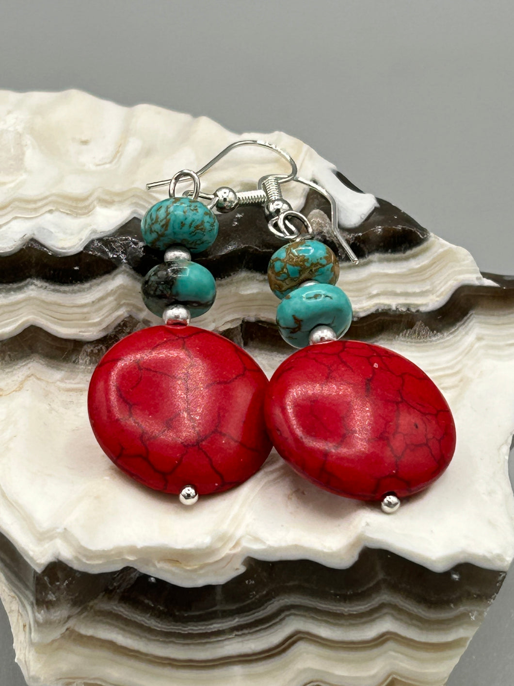 These southwest inspired earrings feature bamboo red coral and turquoise stone beads with silver glass beads.  Measurements: 1 1/2