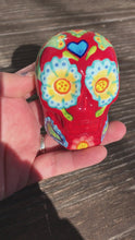 Load and play video in Gallery viewer, Mini Dia de Los Muertos Calavera de Ofrenda, Fire Red Nature Inspired Ceramic Skull Art, Ceramic Day of the Dead Sugar Skull, Hand Painted Skull
