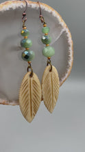 Load and play video in Gallery viewer, Bone Carved Leaf Charm Earrings, Mint Faceted Round Glass Beaded Earrings
