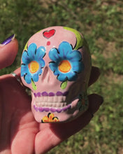 Load and play video in Gallery viewer, Mini Dia de Los Muertos Calavera de Ofrenda, Pastel Pink Nature Inspired Ceramic Skull Art, Ceramic Day of the Dead Sugar Skull, Hand Painted Skull
