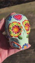 Load and play video in Gallery viewer, Mini Dia De Los Muertos Calavera, Nature Inspired Hand Painted Light Green Ceramic Sugar Skull, Day of the Dead
