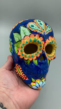 Load and play video in Gallery viewer, Royal Blue Ceramic Sugar Skull. I wanted to create a Dia De Los Muertos skull that represented the eternal love for a special kitty cat in your life. Black cat silhouette is sitting admiring the sun going down. This Day Of The Dead ceramic skull art was created for the cat lovers who adore their sweet kitty. Measurements: H 4” x W 4” x D 5 1/2”
