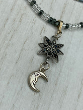 Load image into Gallery viewer, This Dainty Smiling Crescent Moon And Star Silver And Gray Choker Style Necklace features a variety of shimmering glass beads in light silver and gray tones. Varying in shape and size, these beads lend a unique and witchy celestial vibe to the necklace.  Measurements:  Necklace is 15 3/4”adjustable up to 18&quot;
