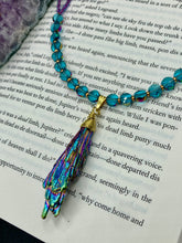 Load image into Gallery viewer, This necklace boasts a stunning Rainbow Kyanite wired stone pendant and two strands of shimmering glass beads. The blues contain hues of pink, gold, blue and green, offering a vibrant and bold addition to any jewelry collection.  Measurements:  Necklace is 17” in length, can be adjusted to 18&quot;
