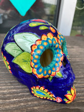 Load image into Gallery viewer, I wanted to create a skully that represented the eternal love for a special kitty cat in your life. Dark royal blue ceramic sugar skull with black cat silhouette is sitting admiring the sun going down. This Day Of The Dead ceramic skull art was created for the cat lovers who adore their sweet kitty. Measurements: H 4” x W 4” x D 5 1/2”
