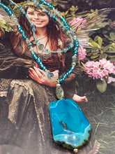 Load image into Gallery viewer, This Vibrant Sea Blue Agate Natural Stone Pendant Choker Style Beaded Necklace includes two strands of glass beads in shades of blues, silver and clear to lend shimmer and color to this large stone pendant. The shorter strand consists of very light blue small glass beads, while the longer strand is primarily a light baby blue. A set of dainty matching earrings completes the look. This beautiful gemstone necklace is the perfect accessory to bring the beach with you in the coming months.
