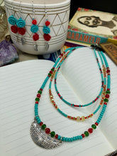 Load image into Gallery viewer, Three strands of Southwestern Style Inspired Adjustable Choker Beaded Necklace features an eye-catching blend of vibrant turquoise, red, green, gold, and yellow glass beads, accented with a wide silver plated tribal pattern pendant.  Measurements:  Necklace is 15 1/2” adjustable up to 18" in length
