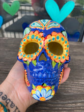 Load image into Gallery viewer, I wanted to create a Dia De Los Muertos skull that represented the eternal love for a special kitty cat in your life. Black cat silhouette is sitting admiring the sun going down. This Day Of The Dead ceramic skull art was created for the cat lovers who adore their sweet kitty. Measurements: H 4” x W 4” x D 5 1/2”
