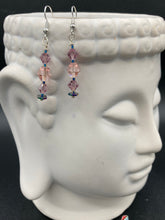 Load image into Gallery viewer, These dainty glass beaded earrings in soft pink and purple, featuring rainbow hematite beads, are perfect for summer ensembles and boho chic looks. An ideal accessory for nature lovers, these earrings will enhance any style.  Measurements: 1 1/2” in length

