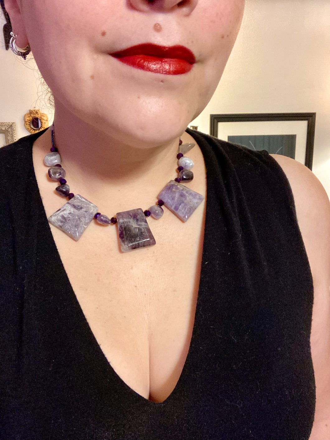 This necklace features large trapezoid-shaped Amethyst pendants and small Amethyst nuggets strung together with shimmery multicolored glass beads, creating a unique and eye-catching statement piece.  Measurements:  Necklace is is 15 1/2” adjustable up to 17