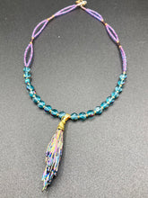 Load image into Gallery viewer, This necklace boasts a stunning Rainbow Kyanite wired stone pendant and two strands of shimmering glass beads. The blues contain hues of pink, gold, blue and green, offering a vibrant and bold addition to any jewelry collection.  Measurements:  Necklace is 17” in length, can be adjusted to 18&quot;
