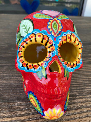 This uniquely handpainted ceramic skull is inspired by the beauty of Sedona, AZ. Features bold fire red color with nature-inspired design for a truly one-of-a-kind mini calavera. Perfect for adding a southwestern touch to your Dia de Los Muertos ofrenda. Measurements: H 4” x W 4” x D 5 1/2”