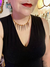 Load image into Gallery viewer, A copper-toned, adjustable Steampunk-style glass beaded necklace is detailed with sharp-drop metal plated hanging beads. Bright orange rectangular tube beads mix with other shapes for an eye-catching effect, while double-hole flat matte copper-toned beads provide a collar finish which makes this piece drape elegantly across the neck. A bold and sophisticated accessory.
