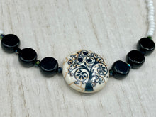 Load image into Gallery viewer, This impressive 24mm reconstituted quartzite lentil bead creates an eye-catching statement piece. The black and white glass beads add a sophisticated touch to its understated tree print. Perfectly suited to casual and formal occasions alike, this stunning necklace will complete any look. It was inspired by the stunning landscapes found in the U.S. National Arboretum in D.C.  Measurements:  Necklace is 17 &quot; in length
