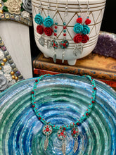 Load image into Gallery viewer, These Southwester Style Silver Feather Light Dainty Beaded Earrings are richly adorned with turquoise, bright red and dark green, and feature silver plated feather charms for a fun, dynamic effect. A perfect match for any Chingona Carbrona, La India Princess, Fierce Goddess Warrior, or Tribal Pattern look.  Measurements: 3” in length
