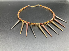 Load image into Gallery viewer, A copper-toned, adjustable Steampunk-style glass beaded necklace is detailed with sharp-drop metal plated hanging beads. Bright orange rectangular tube beads mix with other shapes for an eye-catching effect, while double-hole flat matte copper-toned beads provide a collar finish which makes this piece drape elegantly across the neck. A bold and sophisticated accessory.
