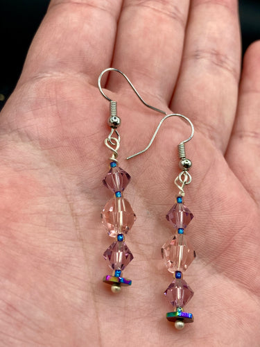 These dainty glass beaded earrings in soft pink and purple, featuring rainbow hematite beads, are perfect for summer ensembles and boho chic looks. An ideal accessory for nature lovers, these earrings will enhance any style.  Measurements: 1 1/2” in length