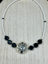 Load image into Gallery viewer, This impressive 24mm reconstituted quartzite lentil bead creates an eye-catching statement piece. The black and white glass beads add a sophisticated touch to its understated tree print. Perfectly suited to casual and formal occasions alike, this stunning necklace will complete any look. It was inspired by the stunning landscapes found in the U.S. National Arboretum in D.C.  Measurements:  Necklace is 17 &quot; in length
