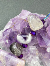 Load image into Gallery viewer, This necklace features large trapezoid-shaped Amethyst pendants and small Amethyst nuggets strung together with shimmery multicolored glass beads, creating a unique and eye-catching statement piece.  Measurements:  Necklace is is 15 1/2” adjustable up to 17&quot;
