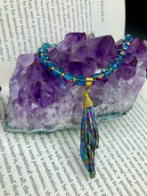 Load image into Gallery viewer, This necklace boasts a stunning Rainbow Kyanite wired stone pendant and two strands of shimmering glass beads. The blues contain hues of pink, gold, blue and green, offering a vibrant and bold addition to any jewelry collection.  Measurements:  Necklace is 17” in length, can be adjusted to 18&quot;

