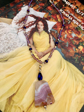 Load image into Gallery viewer, A soft dusty rose agate pendant is accompanied by shimmery beads of dusty rose, blue, dark pink, and gold. Adorned with large deep purple glass beads with a hint of gold shimmer, this stunning necklace set evokes a rose garden.  Measurements:  Necklace is 15” adjustable to 18&quot;
