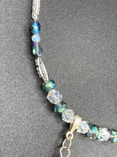Load image into Gallery viewer, This gorgeous, Bohemian-style necklace features a shimmery aqua blue and gold-toned glass beaded design, with a large, faceted rectangular pendant adding dramatic flair. The vibrant and eye-catching colors make it the perfect way to add a pop of color to any ensemble and the draping style will give you a look that is both bold and elegant.  Measurements:    Necklace is 17” - adjustable to 18&quot;, pendant is 2 1/4”
