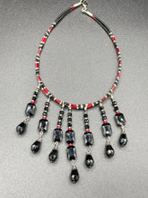 Load image into Gallery viewer, This Vampire Goth style choker necklace features a mix of black and red glass beads with a hanging large tear drop black bead that gives it a depth and complexity of color. Perfect for formal dresses as it gracefully drapes down the neck. Necklace is 15” adjustable to 18"
