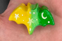 Load image into Gallery viewer, Cute and spooky magnet design to adorn your refrigerator, lockers, workstation, toolbox, or dishwasher. This hand-sculpted clay bat statuette boasts stunning ombre coloration, transitioning from to dark green to light green and then to bright yellow to recreate the breathtaking look of a starry night sky. H 1” x W 2” x D 1/2”
