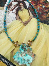 Load image into Gallery viewer, This vibrant and striking double strand necklace features a combination of glass beads in blue and green shades of turquoise, gold and champagne. The two delicate strands are accented with a gold-tone flower-shaped bead, a howlite stone chip dyed in turquoise, and shimmery, cross-faceted champagne-colored glass beads to complete the dramatic look.  Measurements:   Necklace is 17” and can be adjusted up to 19"
