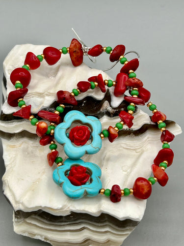 These bamboo coral red stone chip earrings feature tiny turquoise, green, and gold glass beading. Accenting the vibrant design is a turquoise flower pendant with quartzite rose beads for added detail. Measurements: 2 1/4