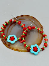 Load image into Gallery viewer, These bamboo coral red stone chip earrings feature tiny turquoise, green, and gold glass beading. Accenting the vibrant design is a turquoise flower pendant with quartzite rose beads for added detail. Measurements: 2 1/4&quot; length 
